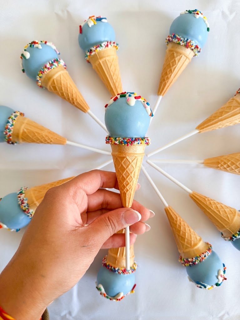Blue ice cream cone shaped cake pops with rainbow sprinkles