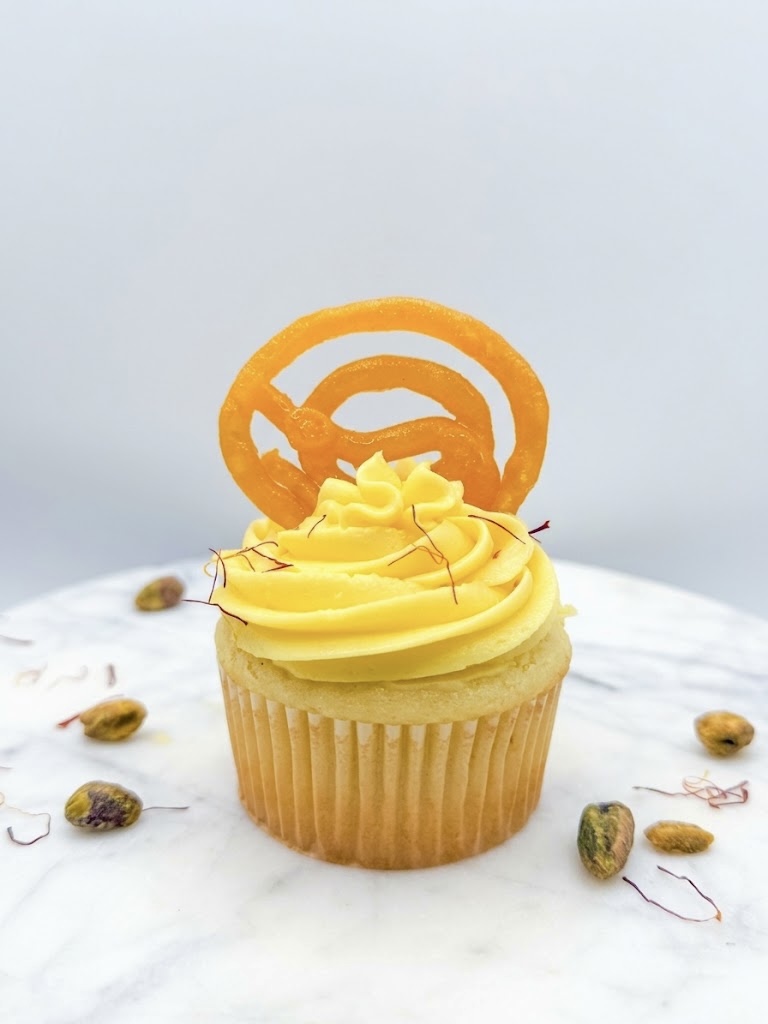 Jalebi & Rabdi cupcake with saffron cream frosting topped with a crisp jalebi
