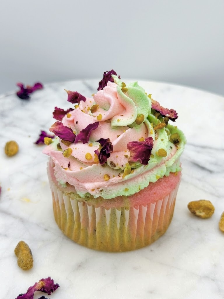 Pistachio Rose cupcake with pink and green rose cream, crushed pistachios, and dried rose petals