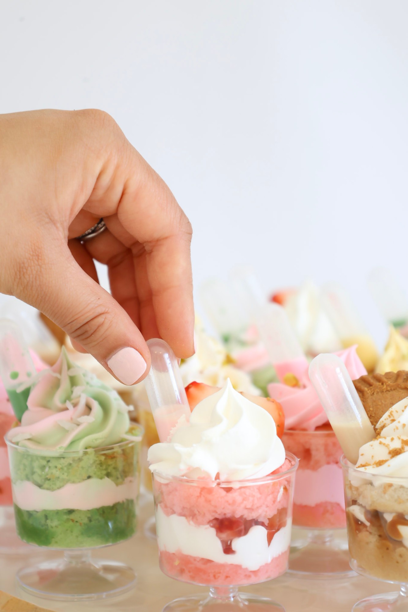 Close-up of assorted dessert cup flavors, including strawberry, Biscoff, and matcha